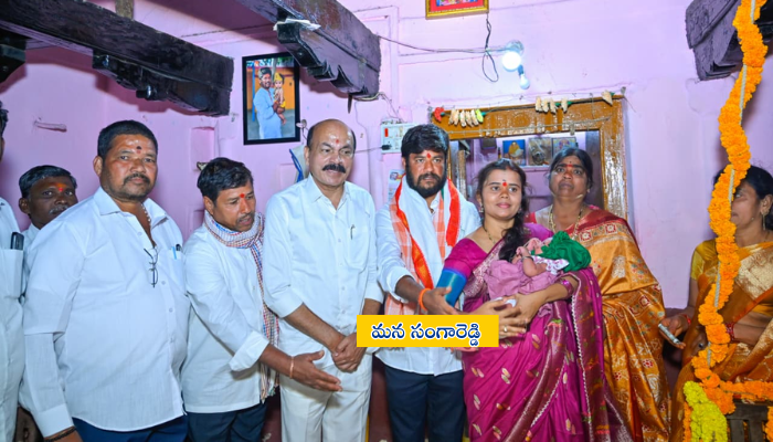 Sangareddy MLA Chintha Prabhakar and his son Chintha Sainath blessing the newborn during the traditional Tottela ceremony at Kambalapally village, Sadashivpet mandal